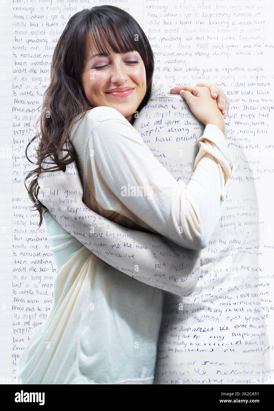 Embracing the english language. A young woman embracing another person who is actually part of the words on the wall. Stock Photo