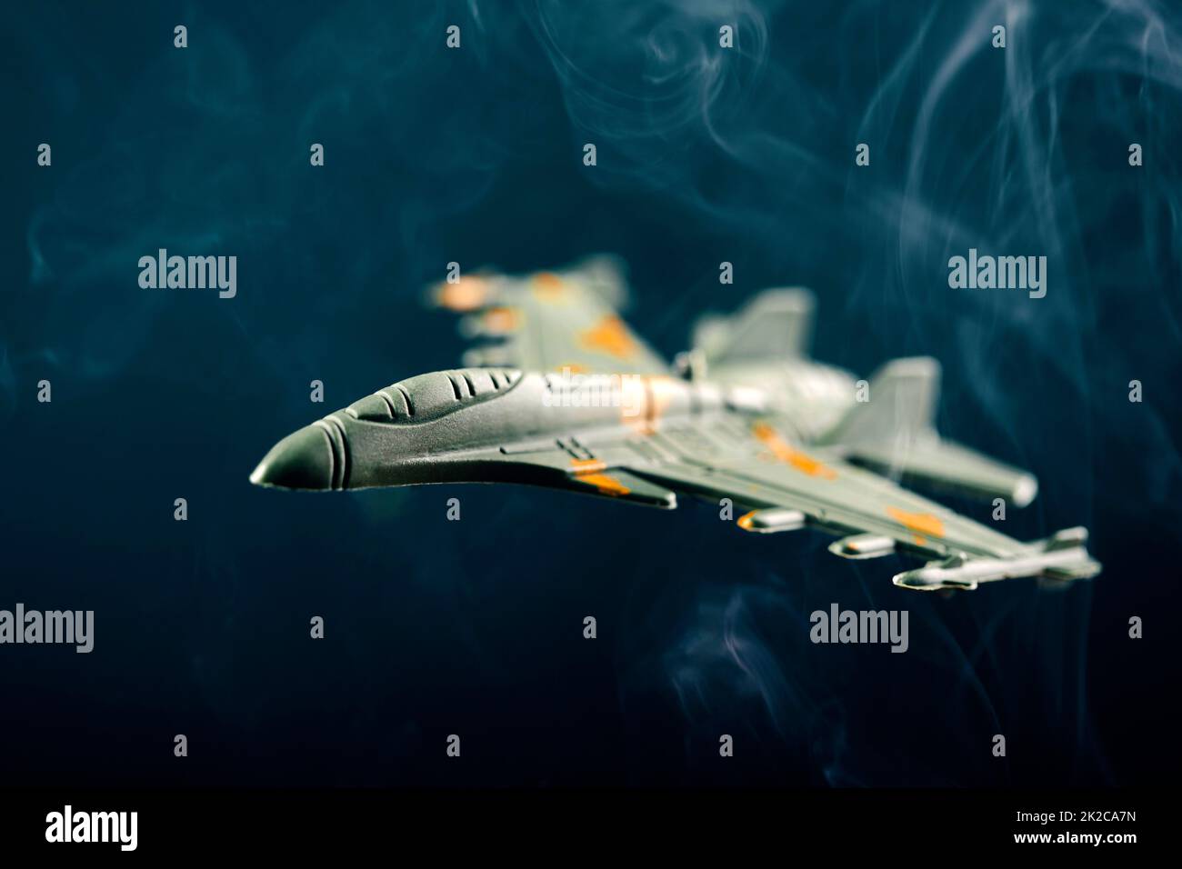 Military aircraft silhouette in smoke Stock Photo