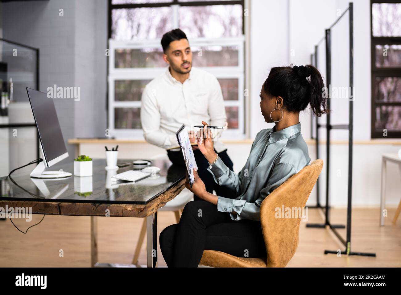 Two Happy Young Businesspeople Working On Computer Stock Photo