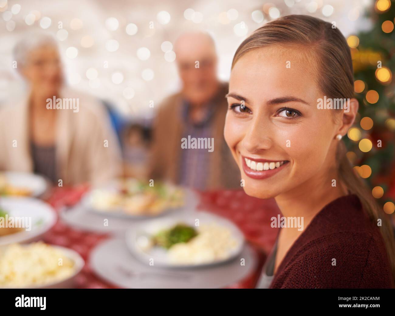 Get ready for a Christmas feast. A family sitting around the table at Christmas. Stock Photo