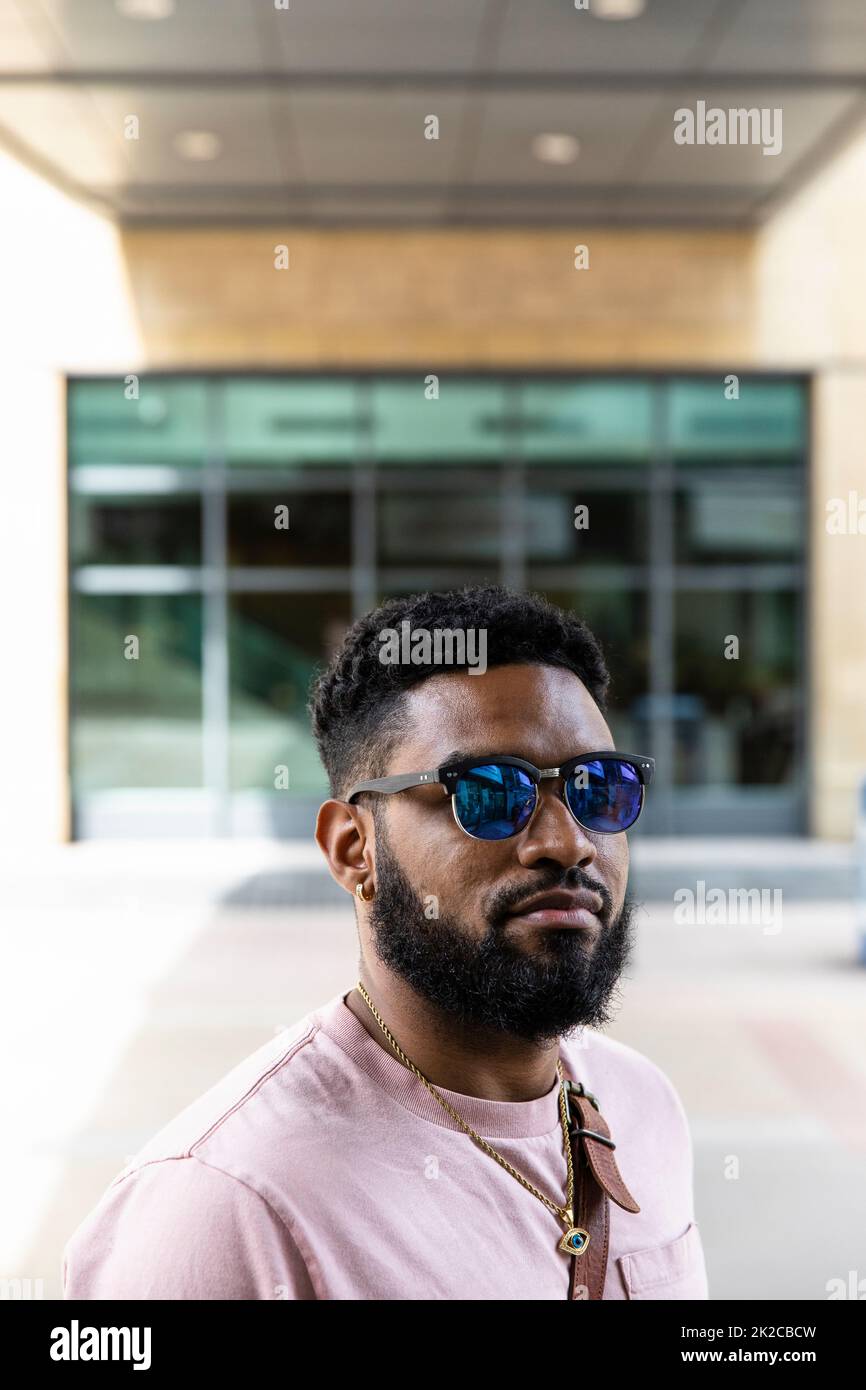 Portrait confident handsome man in sunglasses on sidewalk Stock Photo