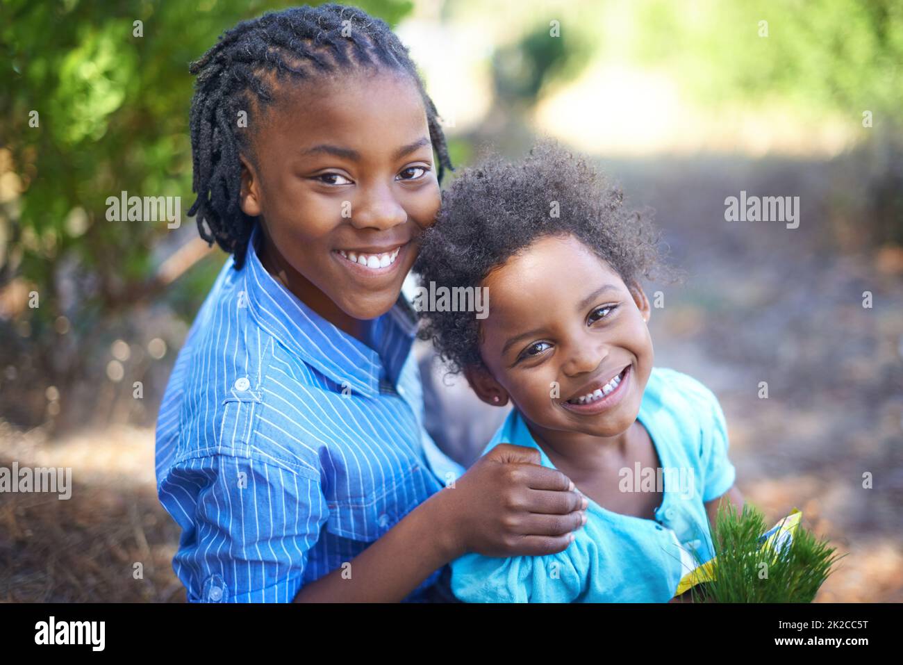 Hes an excellent big brother. Cute african american siblings spending time together in nature. Stock Photo