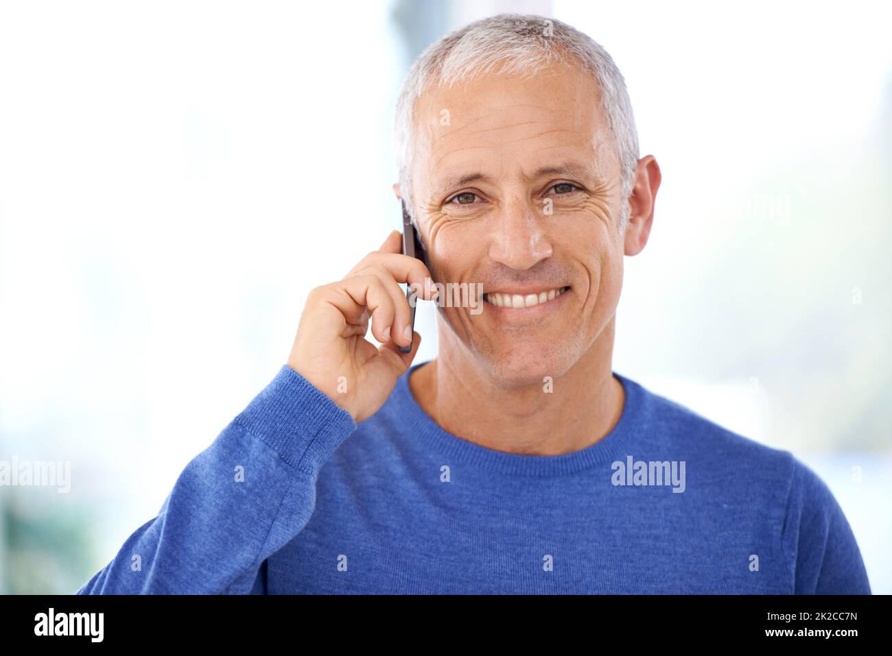 Keeping in touch with friends and family. A mature man having a