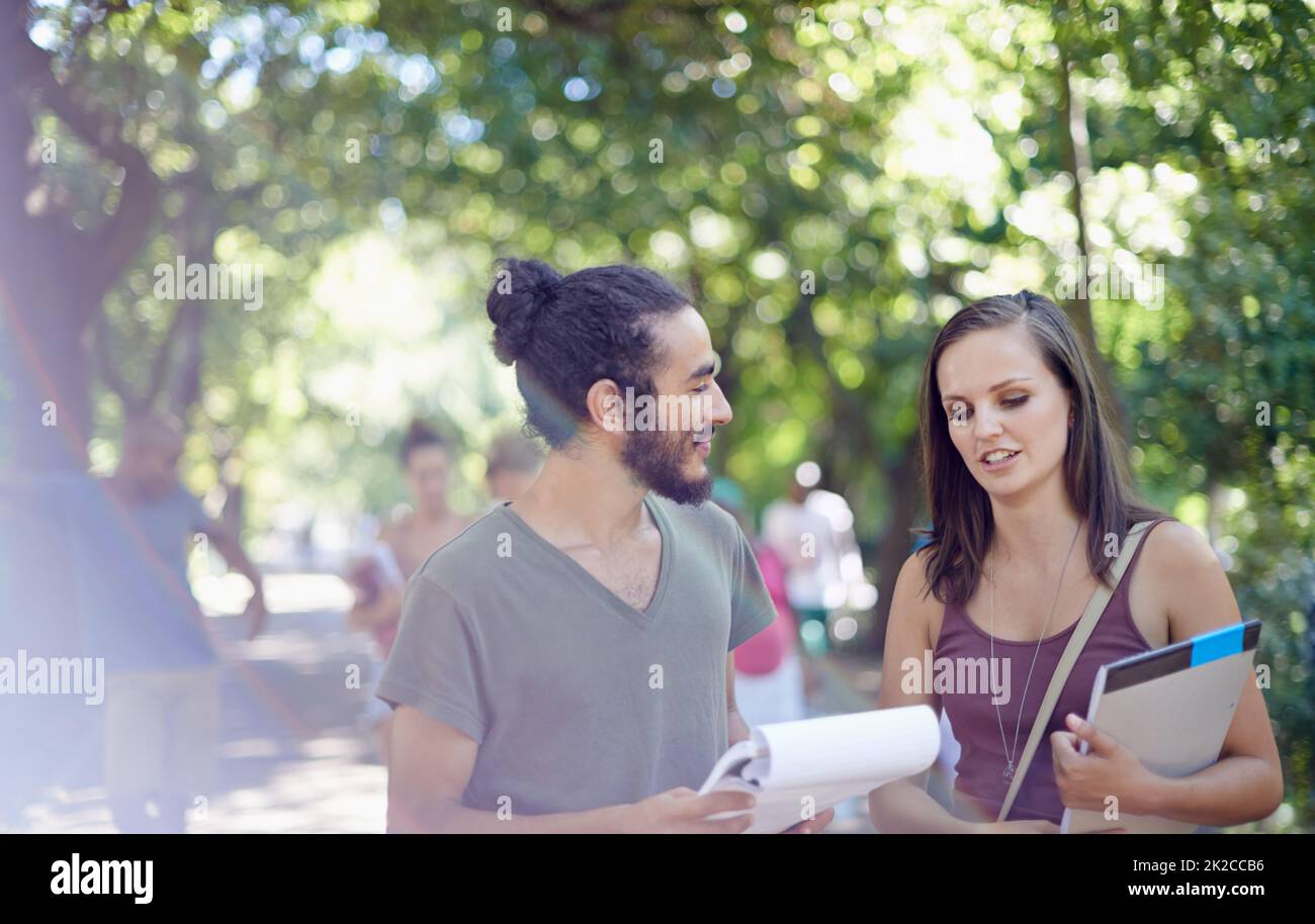 Catching up before the next class. Cropped shot of a male and female student on campus. Stock Photo