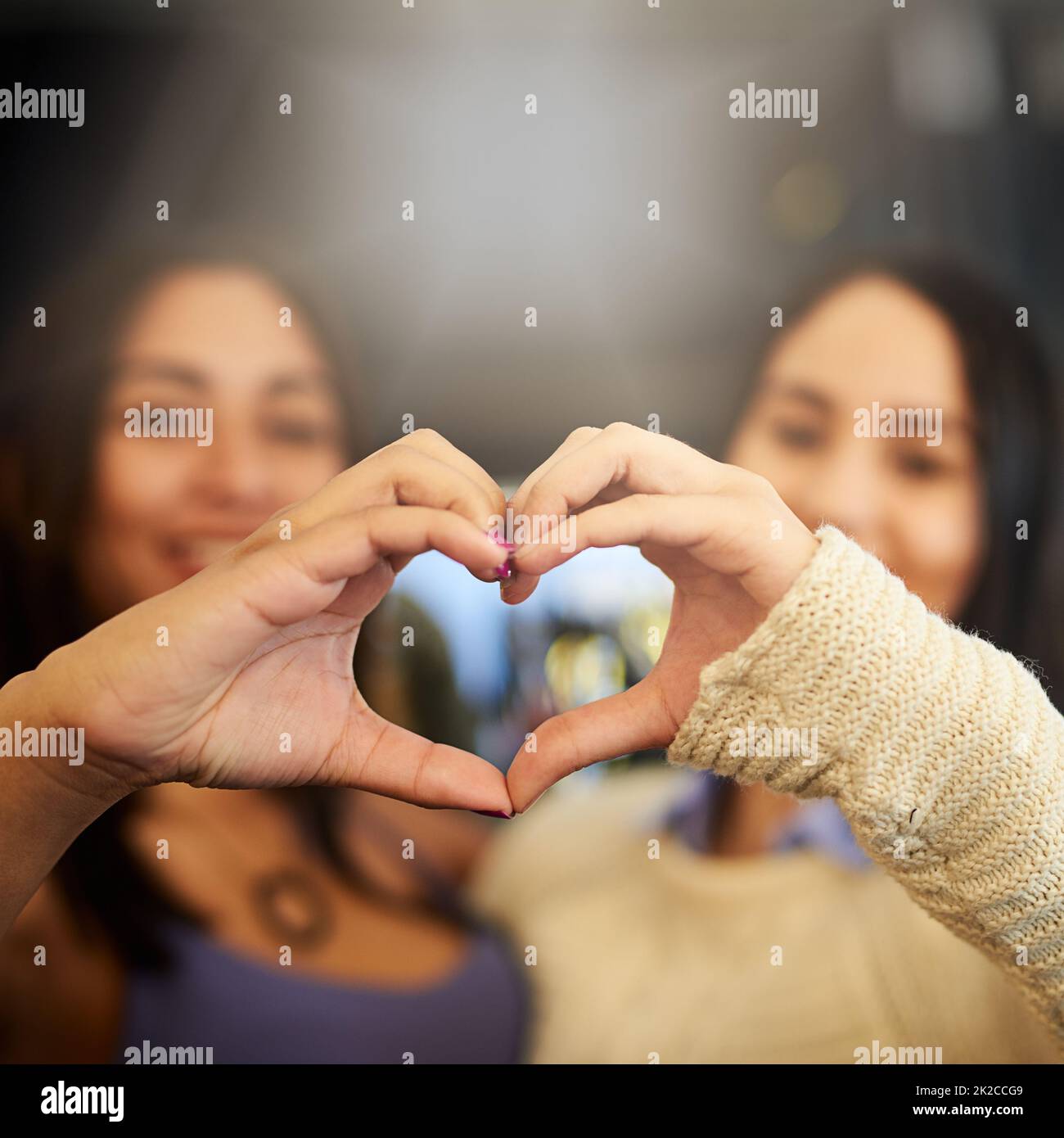 Friends making heart shape hands hi-res stock photography and ...