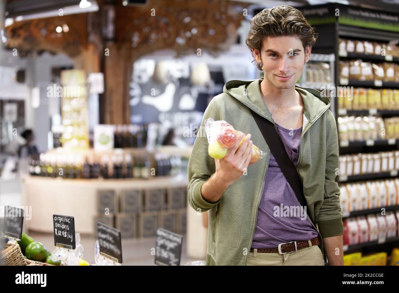 You know what they say, an apple a day.... A young man holding his bag of apples. Stock Photo