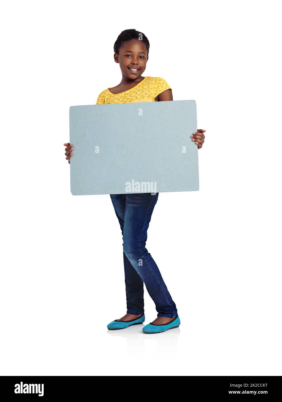 Growing into womanhood. Full length studio shot of an african teenage girl holding a blank board. Stock Photo