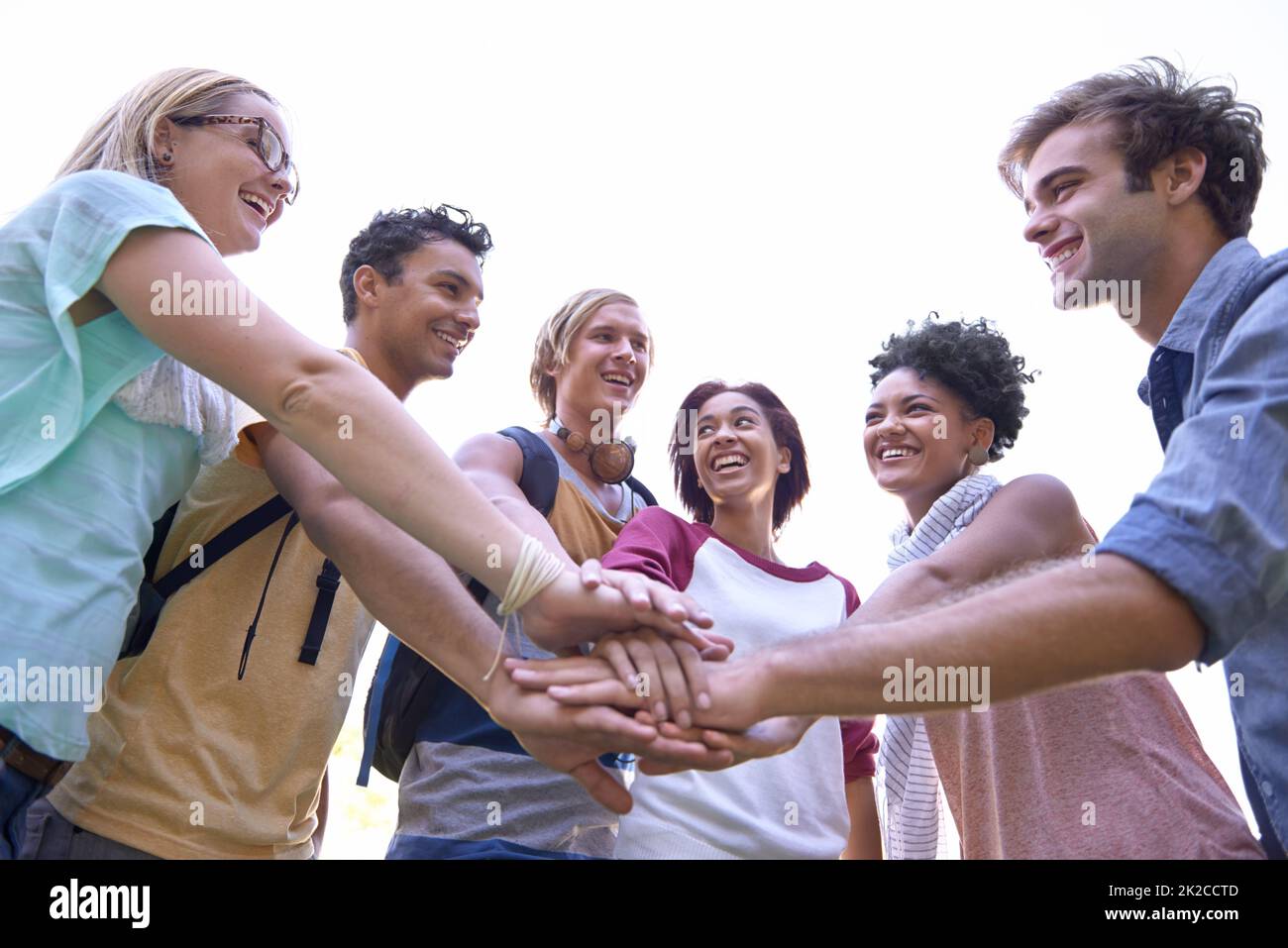 Motivating each other. Shot of a group of students putting their hands in a huddle. Stock Photo