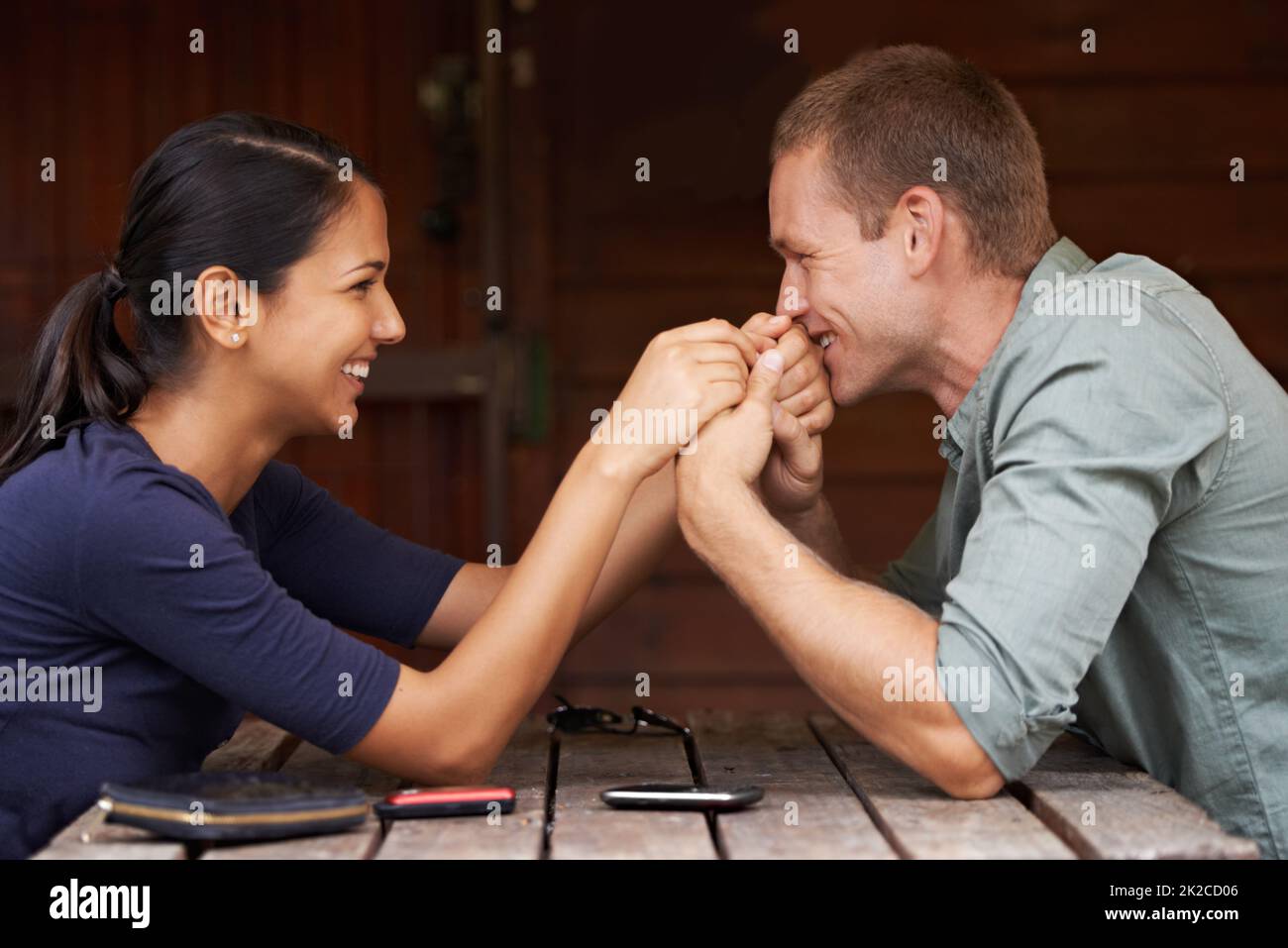 I love you Baby. A cute multi-racial couple sitting together and holding hands outdoors. Stock Photo