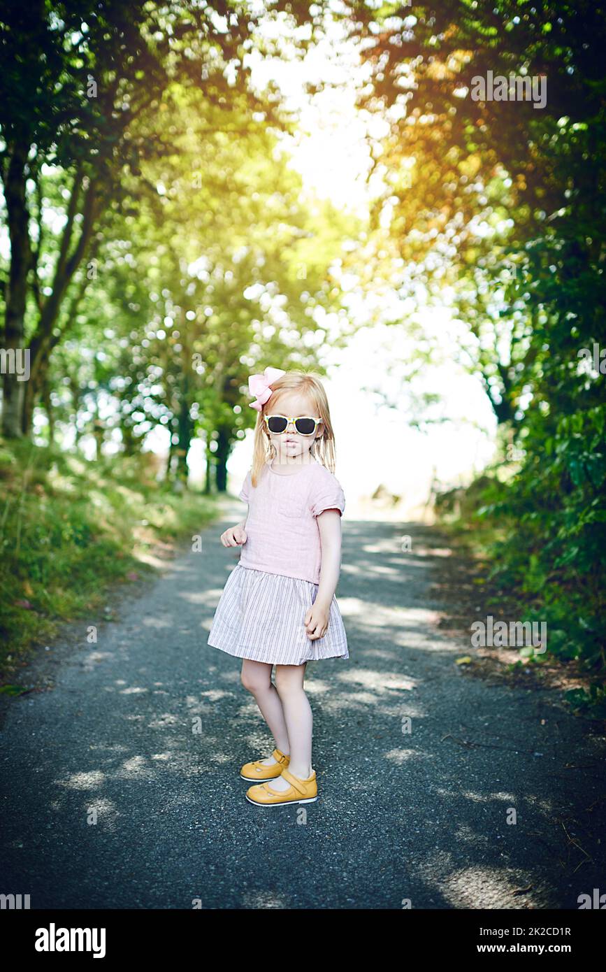 So much of stylishness. Portrait of an adorable little girl standing outdoors. Stock Photo