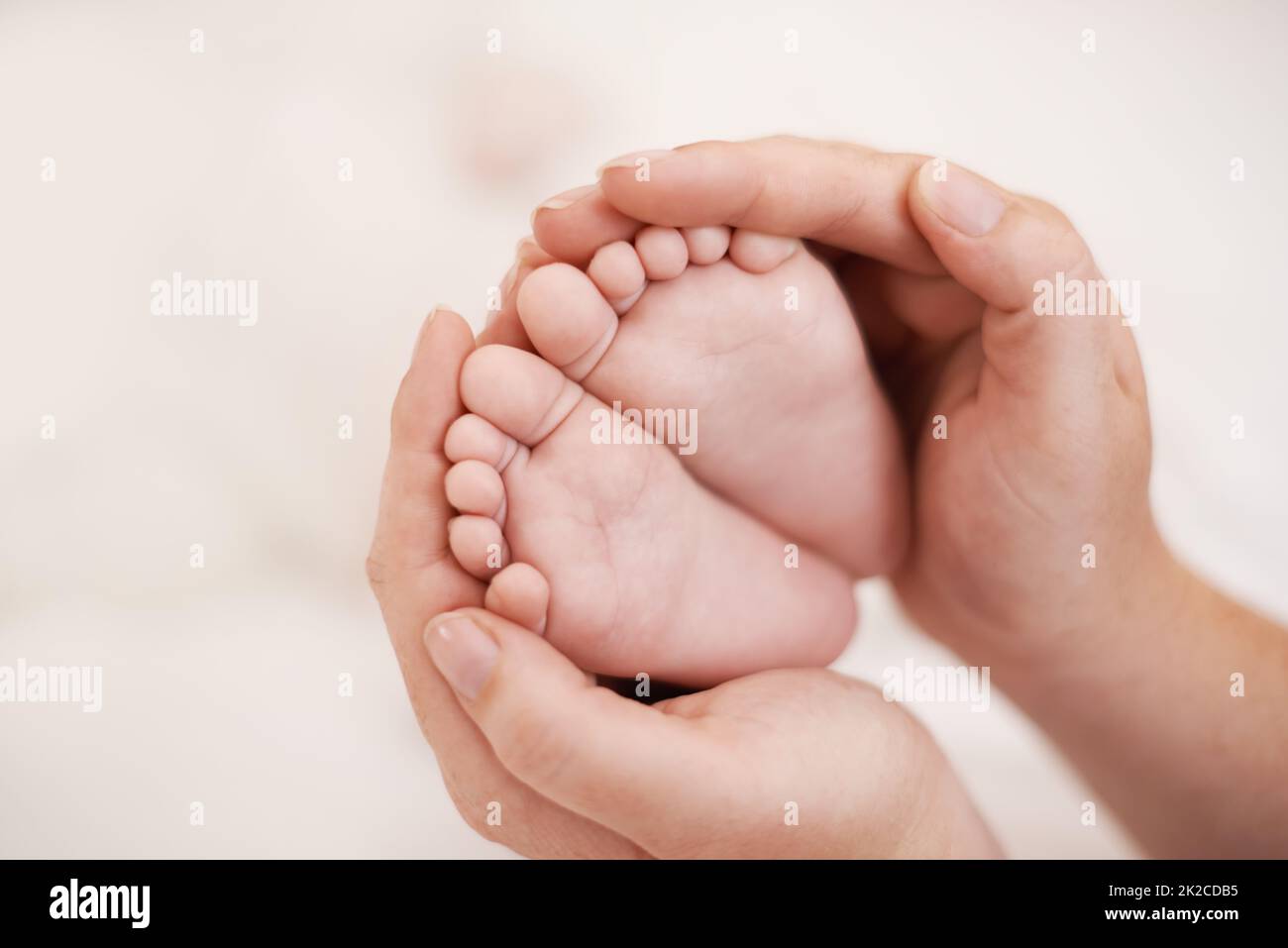 Such tiny little feet. Cropped shot of mother holding her babies feet