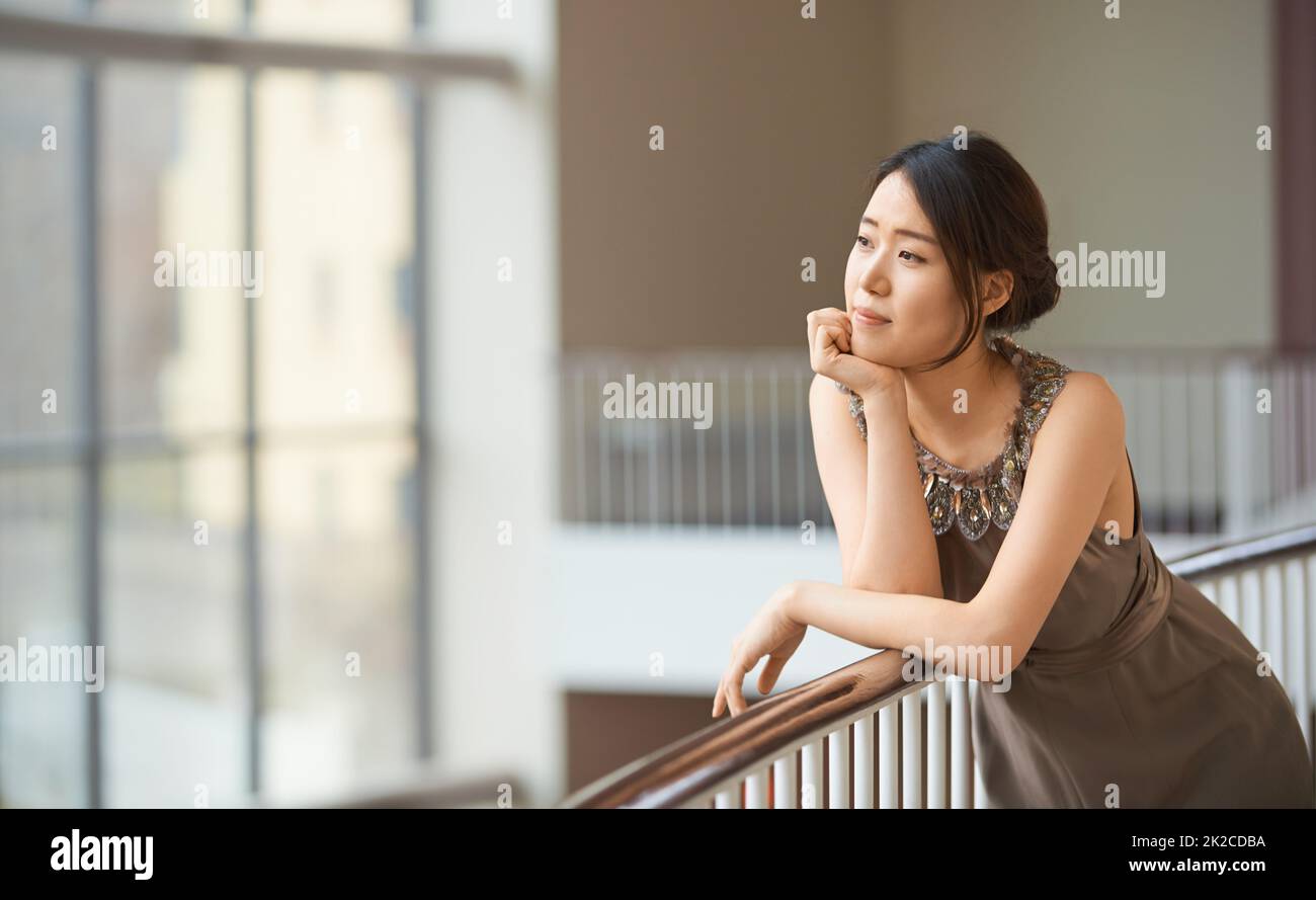 High society dreamer. Shot of an elegantly dressed young woman. Stock Photo