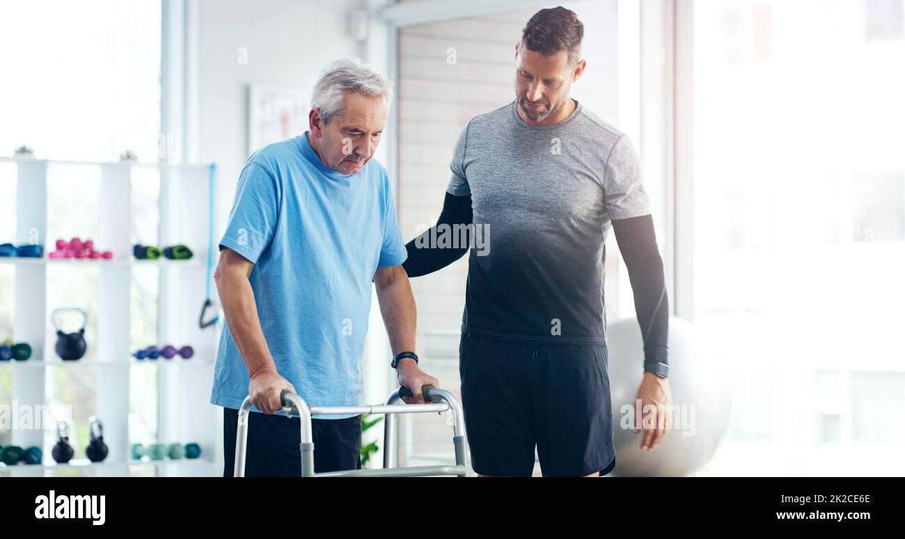 By his side every step of the way. Shot of a male doctor doing some physiotherapy with a senior patient at hospital. Stock Photo