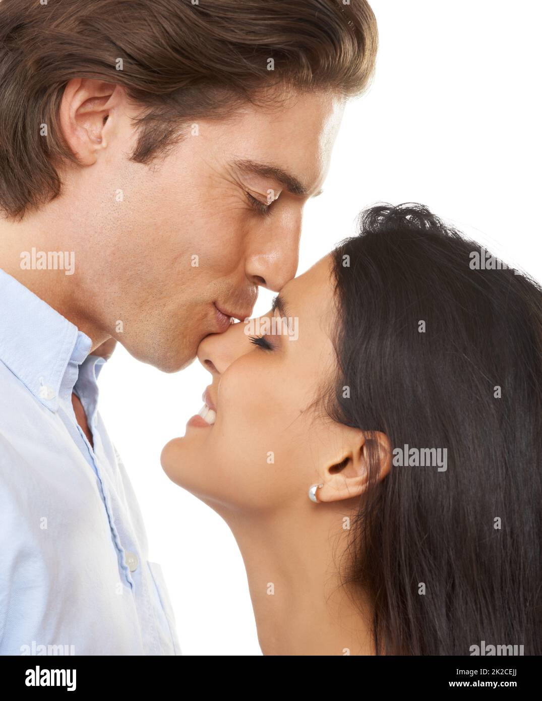 Shes adorable. A multi-ethnic couple isolated on a white background. Stock Photo