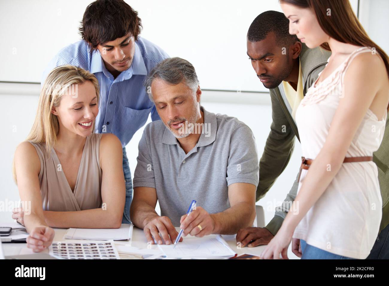 Choosing the right models for their campaign. A group of business people choosing models for an advertising campaign they are working on. Stock Photo
