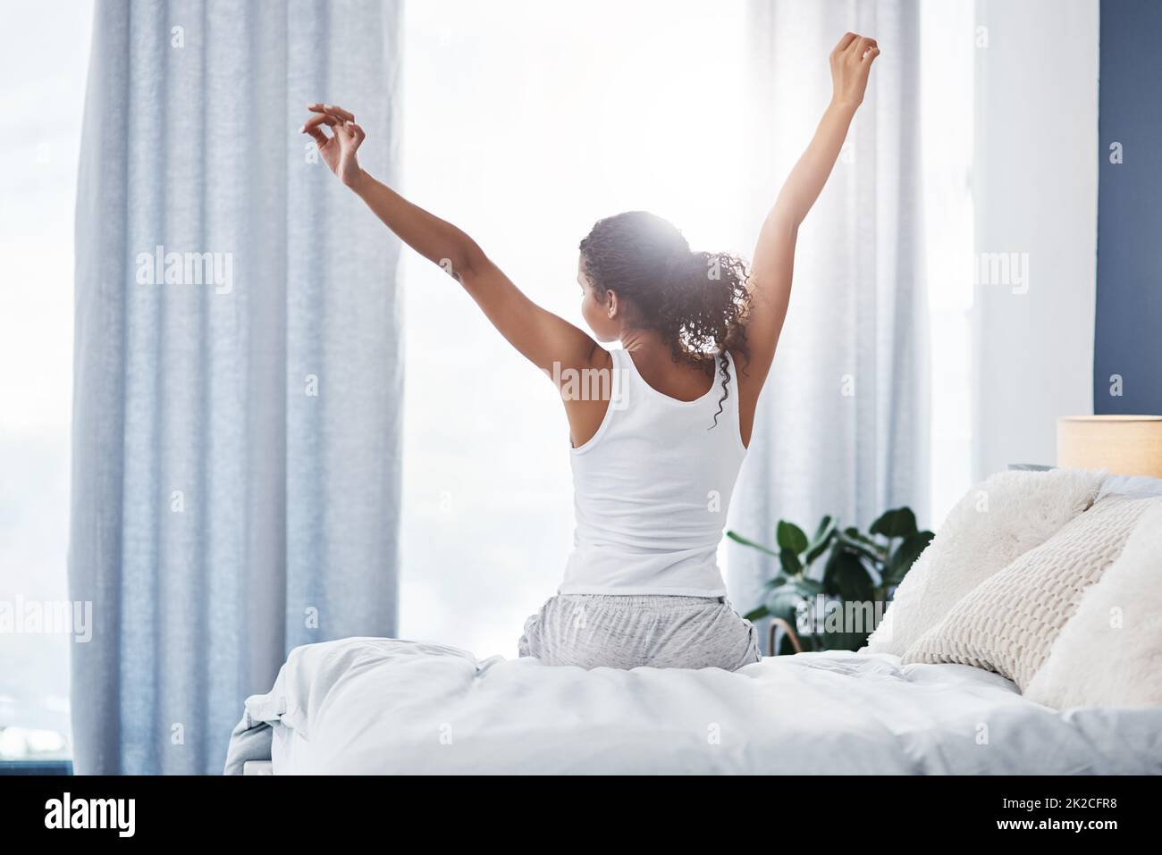 black woman in a bed with curtains mosquito net style boudoir Stock Photo -  Alamy