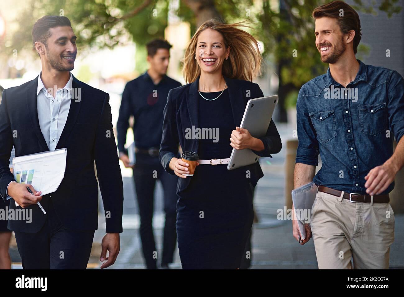 The team that keeps up with the pace of business. Shot of corporate colleagues walking down the street. Stock Photo