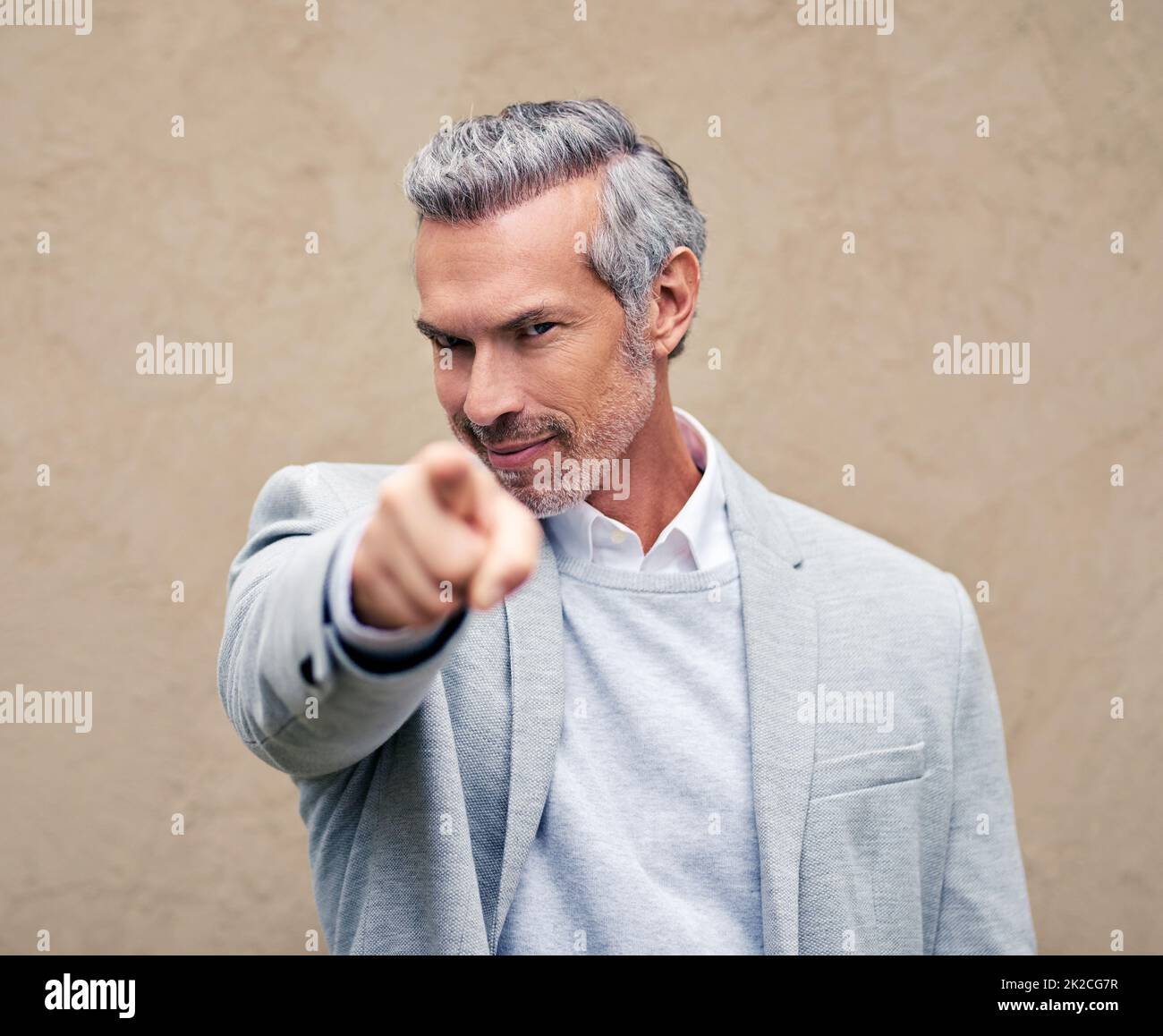 I choose you. Cropped shot of a smartly dressed mature businessman pointing outside. Stock Photo