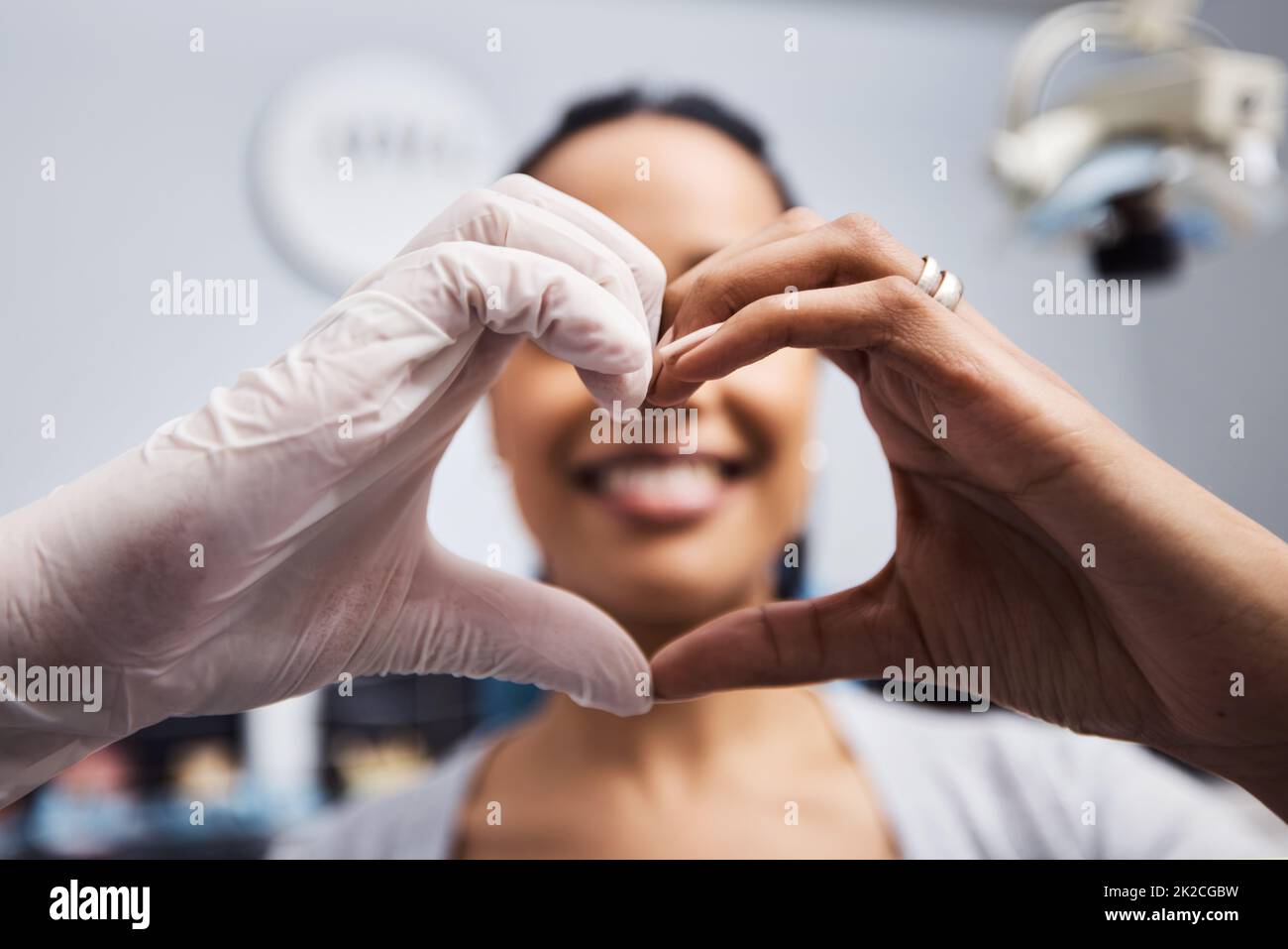 We love to see you smile just like you do. Cropped shot of a dentist and patient making a heart