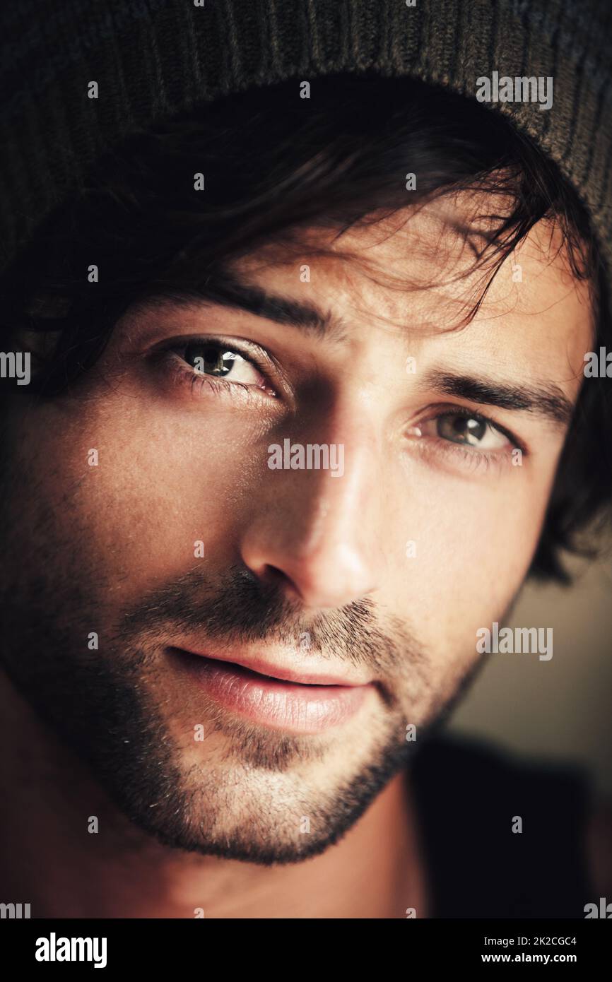 Hes any girls dream guy. Portrait of an attractive and ruggedly handsome man wearing a woolen cap. Stock Photo