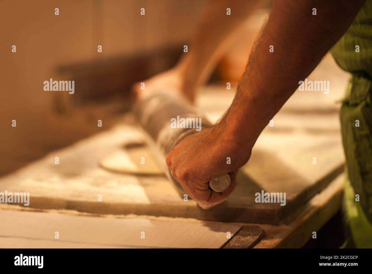 Pizza in creation. Cropped shot of a person rolling out pizza dough. Stock Photo