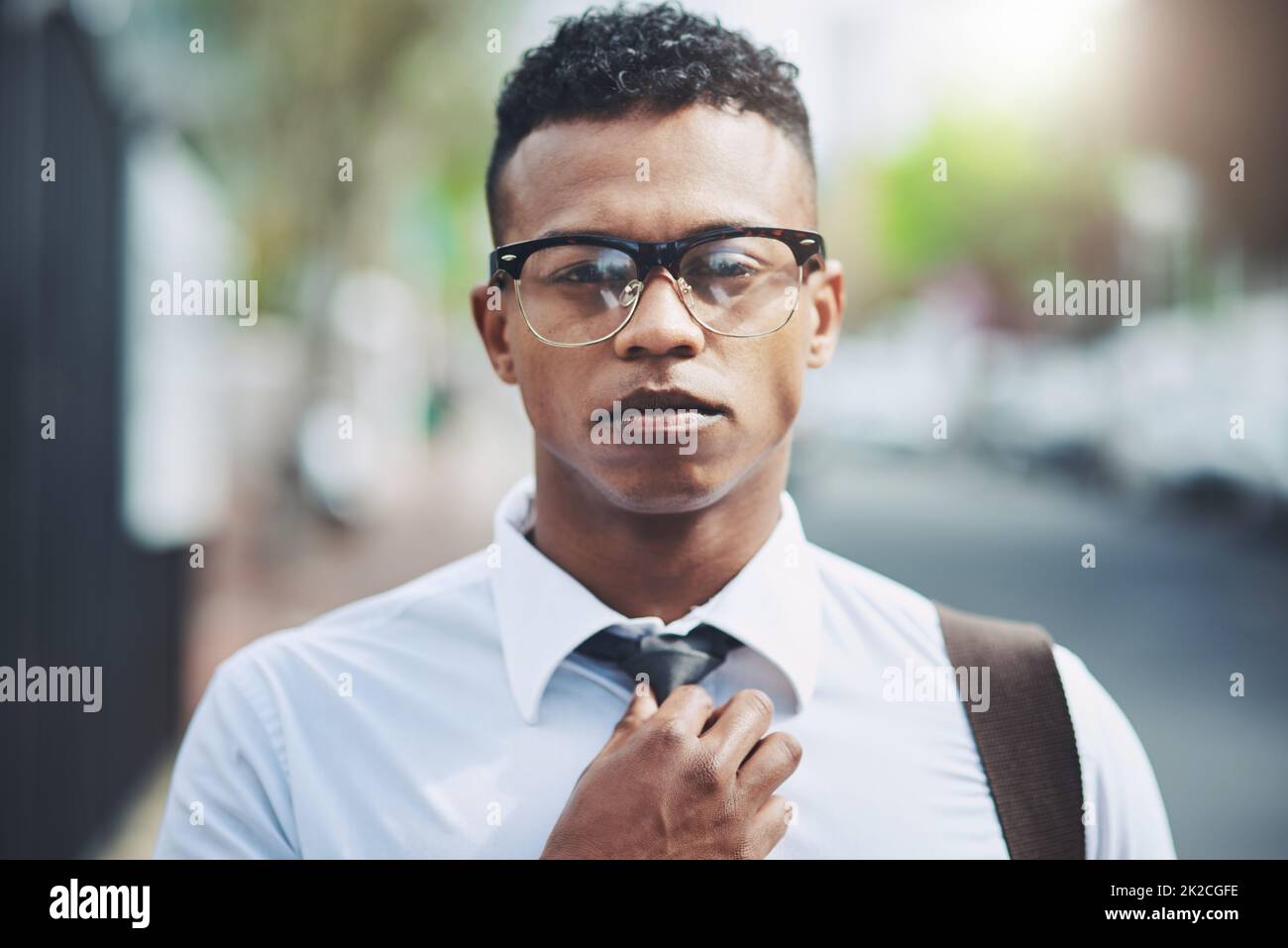Young man adjusting glasses outdoors hi-res stock photography and images -  Alamy