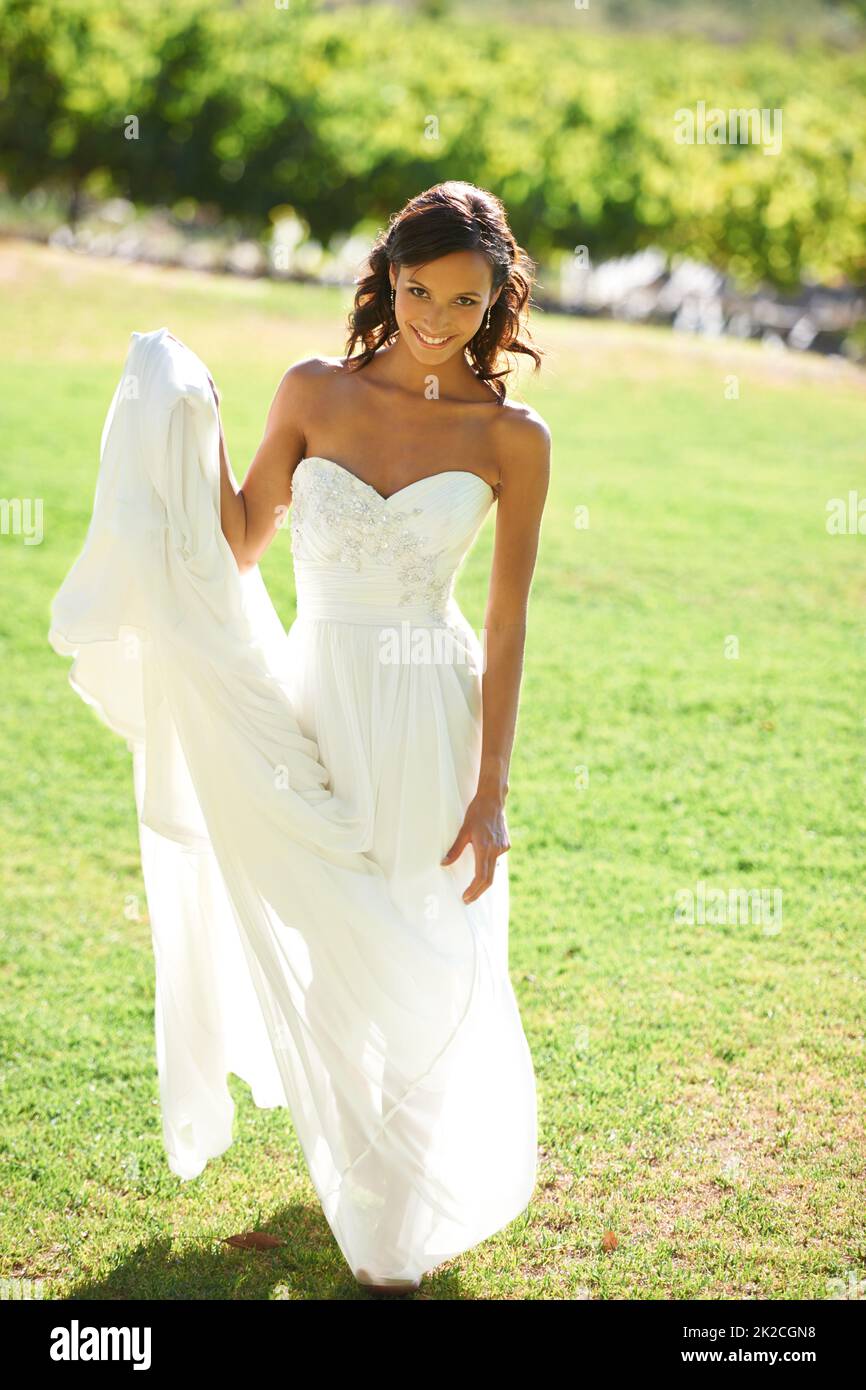 Bridal beauty. A beautiful bride standing in front of a vineyard. Stock Photo