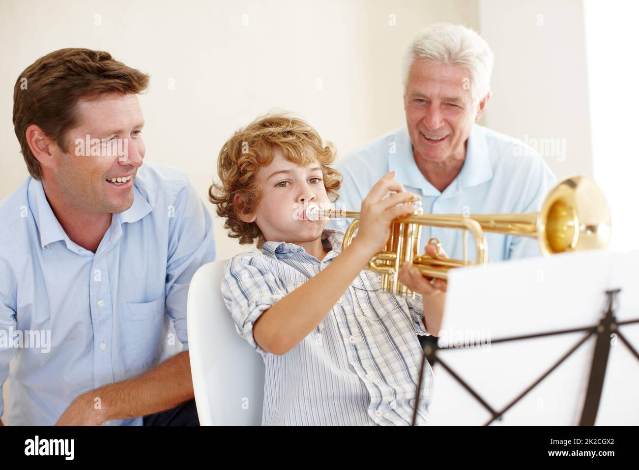 Musical talent runs in this family. Shot of a cute little boy playing the trumpet while his