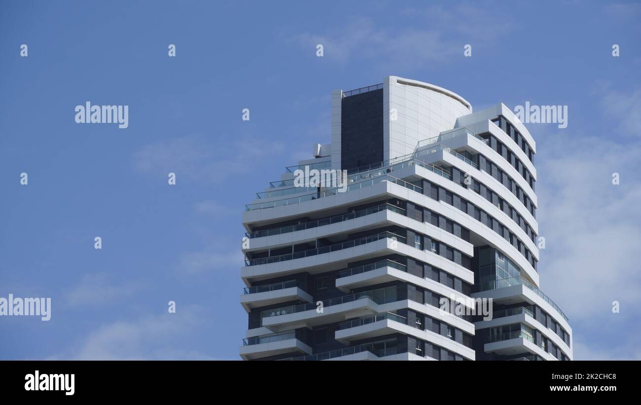 High-rise Apartment Building against blue sky. Modern, luxury apartment building with blue sky at background. Israel Stock Photo