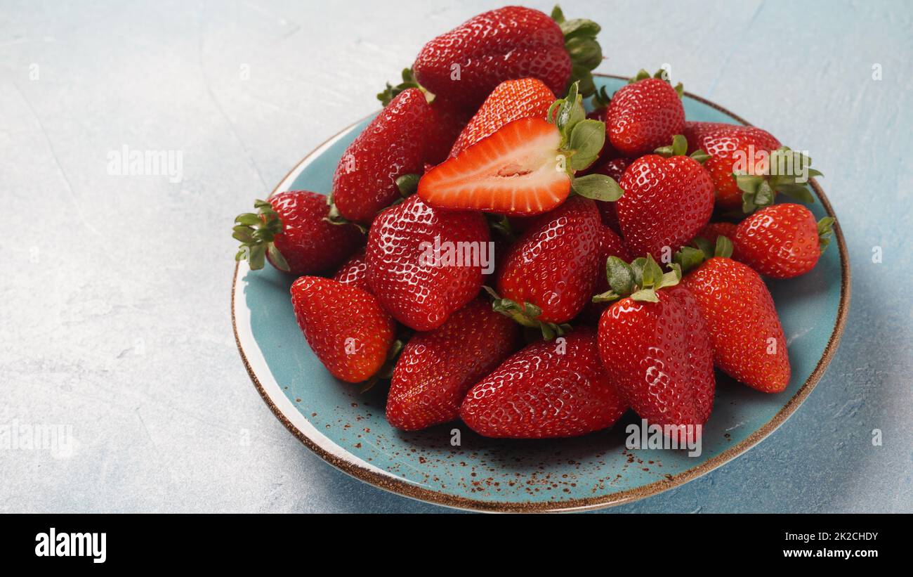 Strawberry fresh organic fruit in a plate. Strawberries with leaves ...