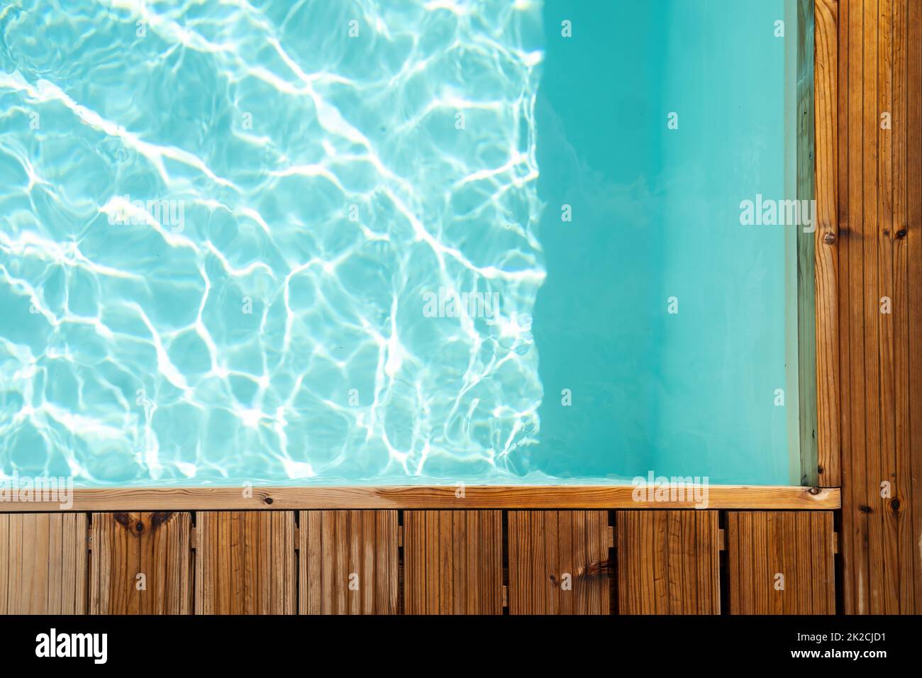 Background with wooden board on swimming pool Stock Photo
