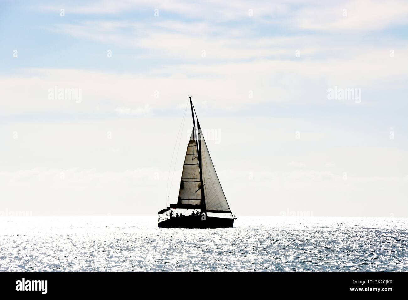 Segelschiff im Gegenlicht - Symbolbild fÃ¼r Freiheit und Fernweh Stock Photo