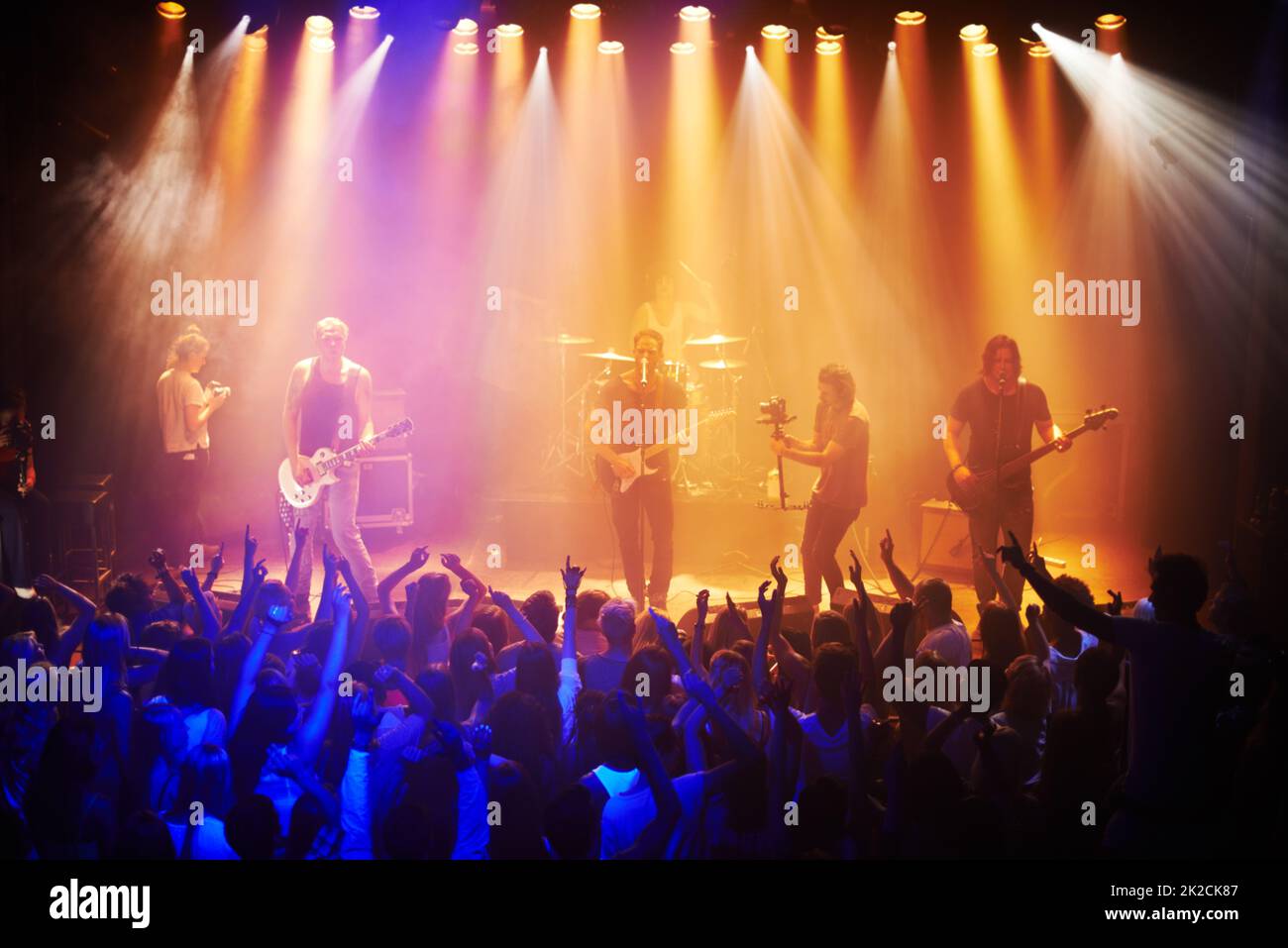 Shot of a large crowd at a music concert-This concert was created for the sole purpose of this photo shoot, featuring 300 models and 3 live bands. All people in this shoot are model released Stock Photo