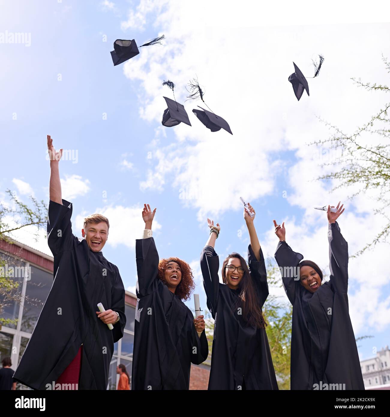 Woohoo Bring it on. Low angle shot of student throwing their graduation