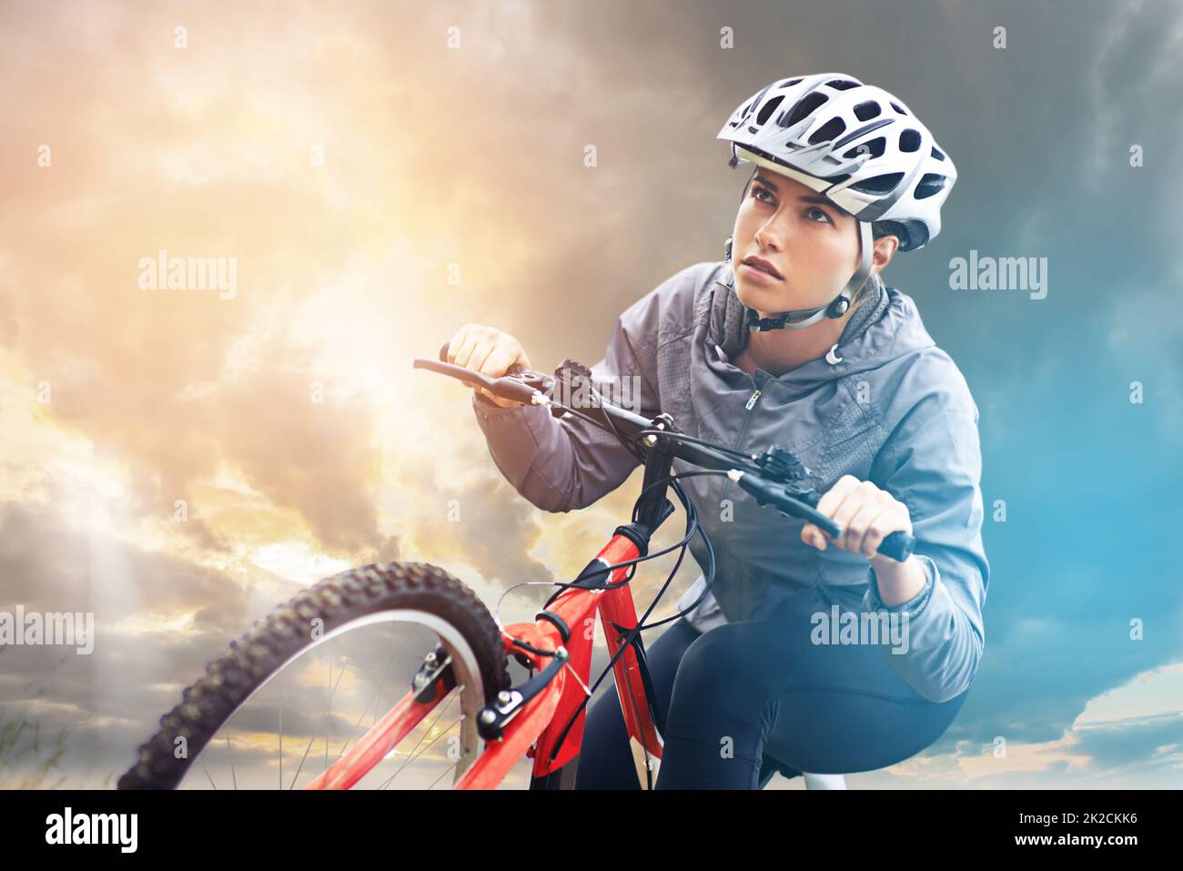 Bicycles may change, but cycling is timeless. Shot of a female mountain biker out for an early morning ride. Stock Photo