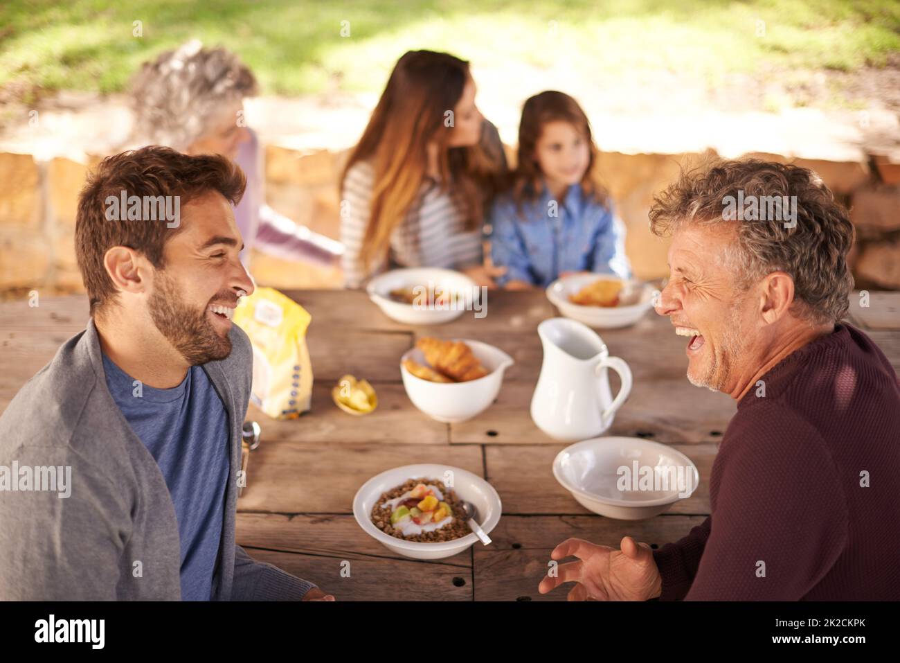 Starting the day with breakfast and laughter. Cropped shot of a family having a meal together outside. Stock Photo