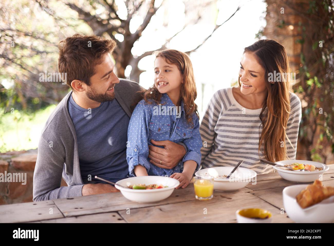 Delightful breakfast time. Cropped shot of a family having a meal together outside. Stock Photo