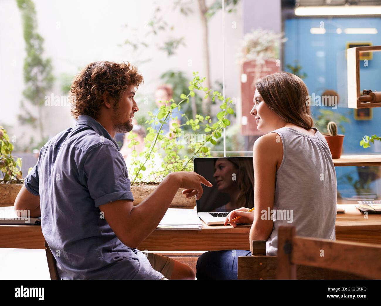 Studying at the coffee shop. Shot of two young students going over some