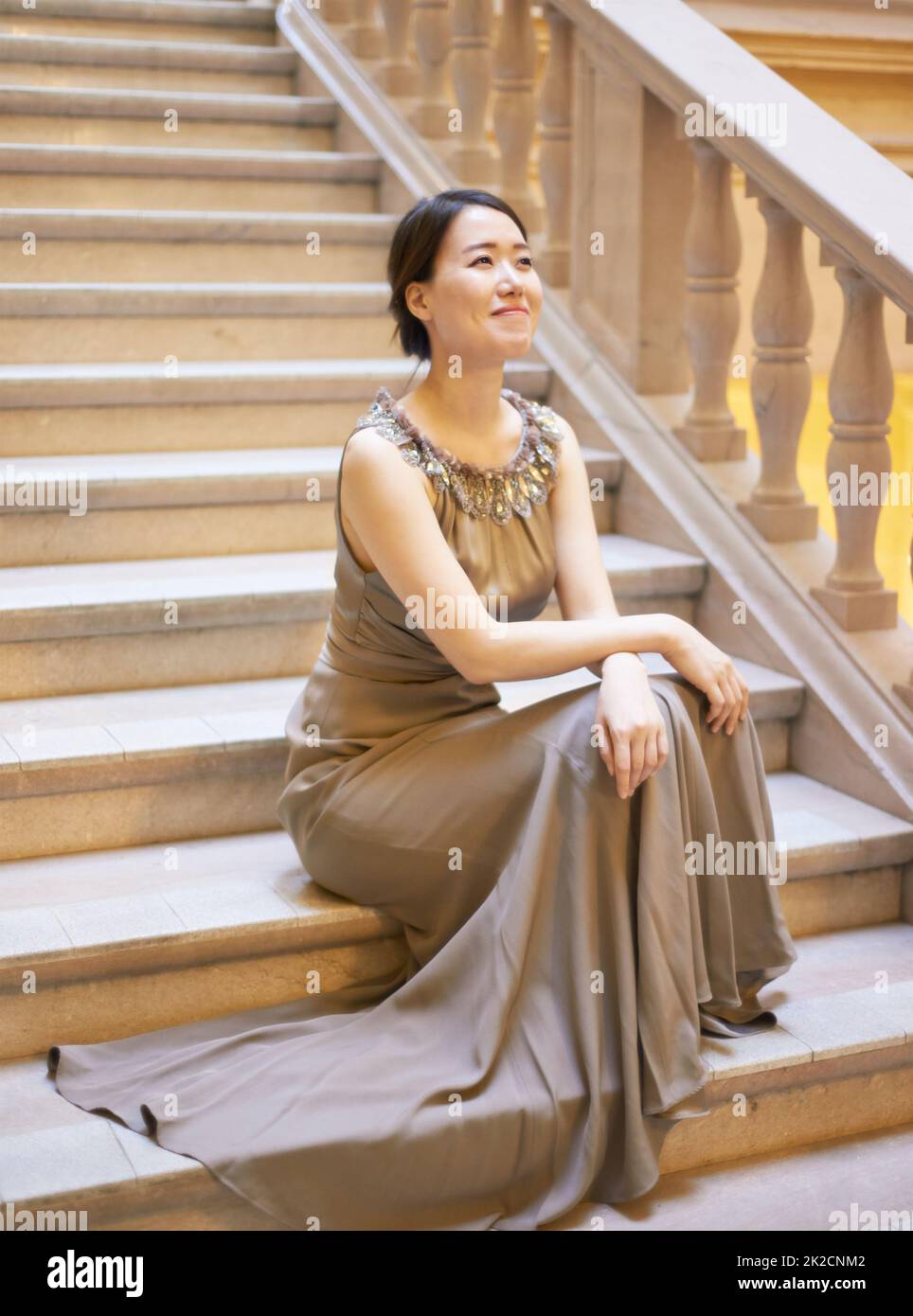 Perfect elegance. Shot of an elegantly dressed young woman sitting on a staircase. Stock Photo