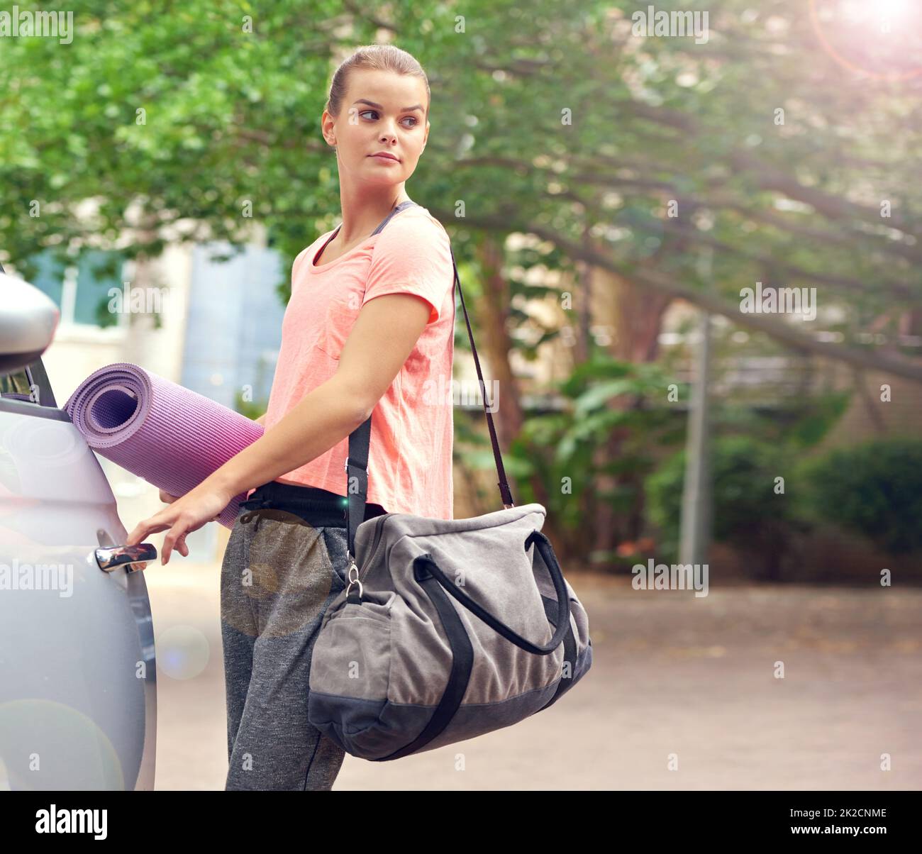 Woman carrying a yoga mat hi-res stock photography and images - Alamy