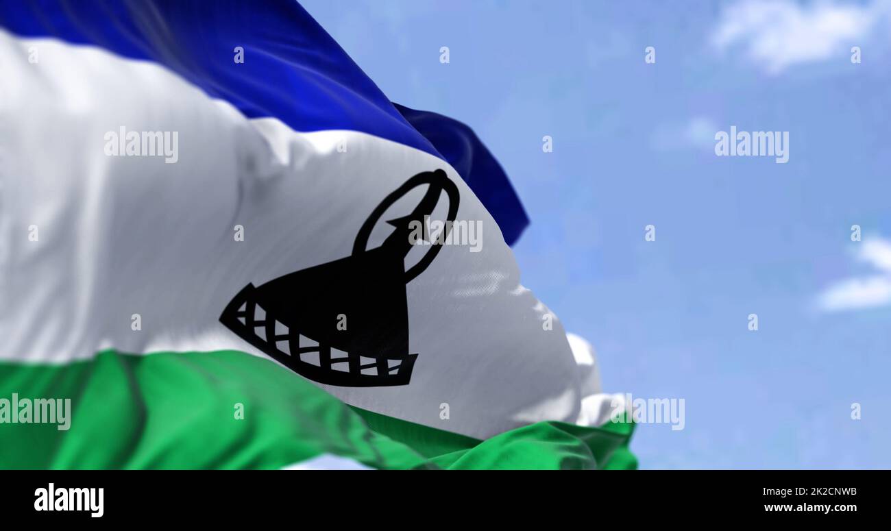 Detail of the national flag of Lesotho waving in the wind on a clear ...