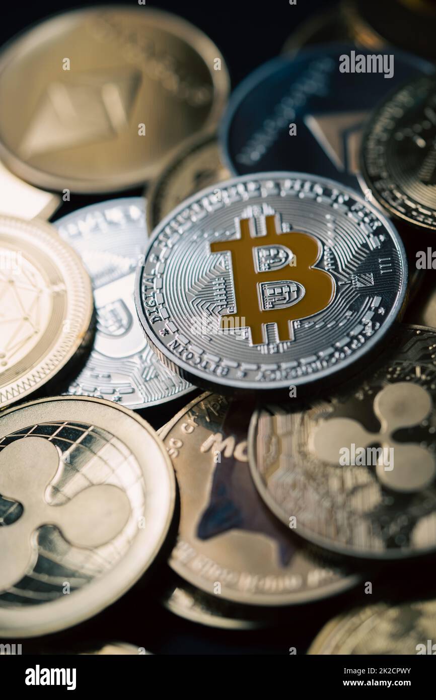 Close up shot of a silver Bitcoin in a stack, among other various digital cryptocurrencies . Stock Photo