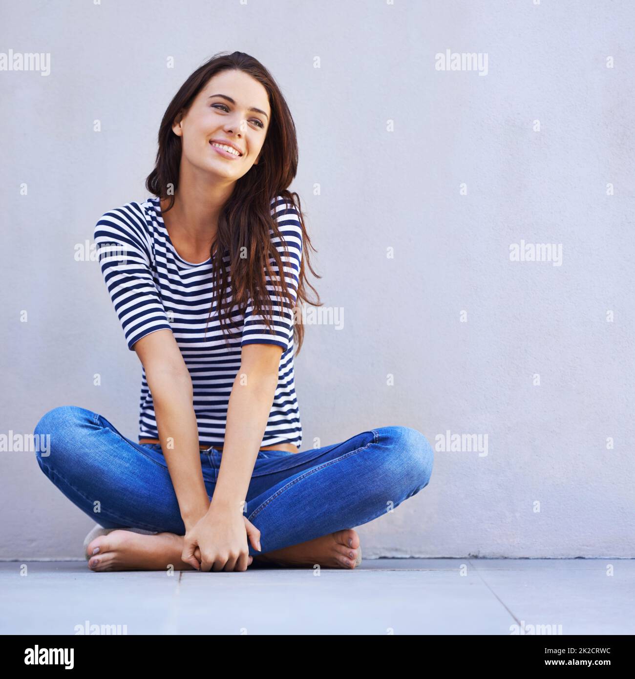 Life is just grand. A beautiful young woman looking thoughtful while