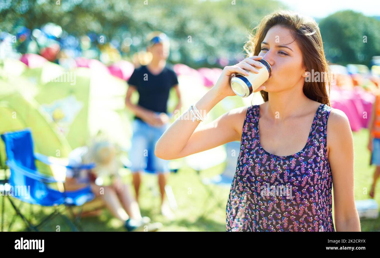 Quenching her thirst. Shot of a young woman drinking a can of beer at
