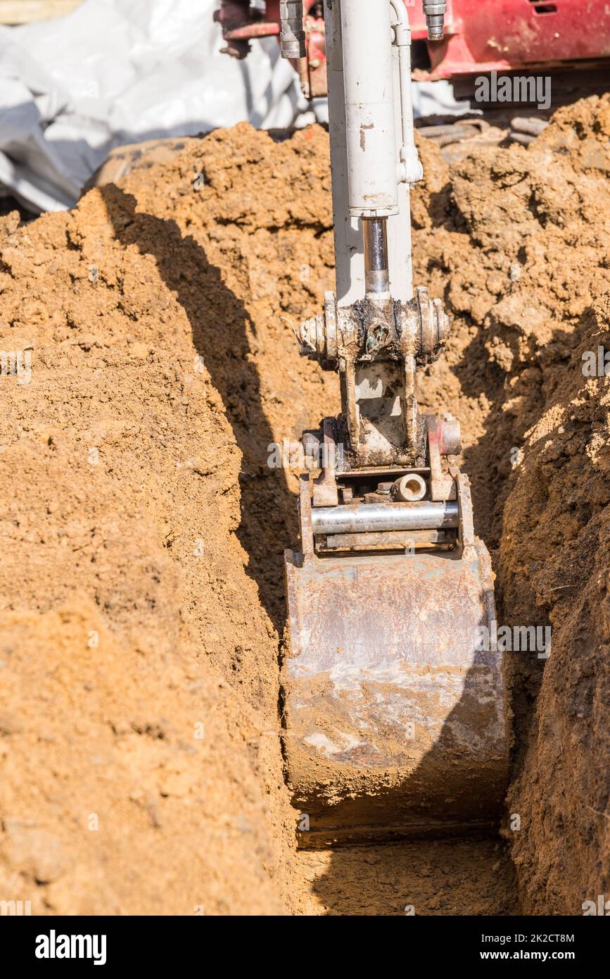 Small excavator on a construction site for excavation and excavation work Stock Photo