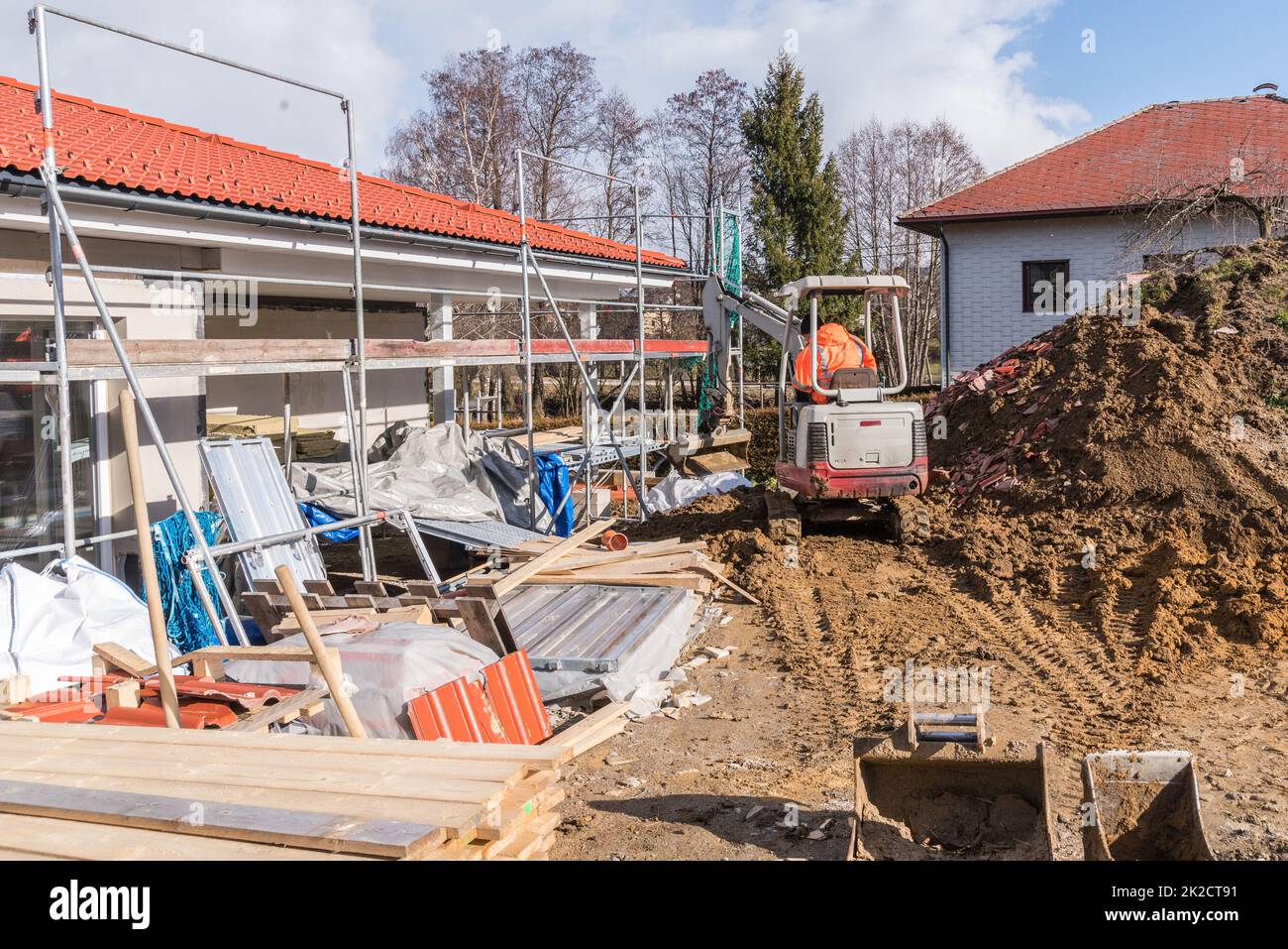 Construction site when building a house and earthworks with a small excavator Stock Photo
