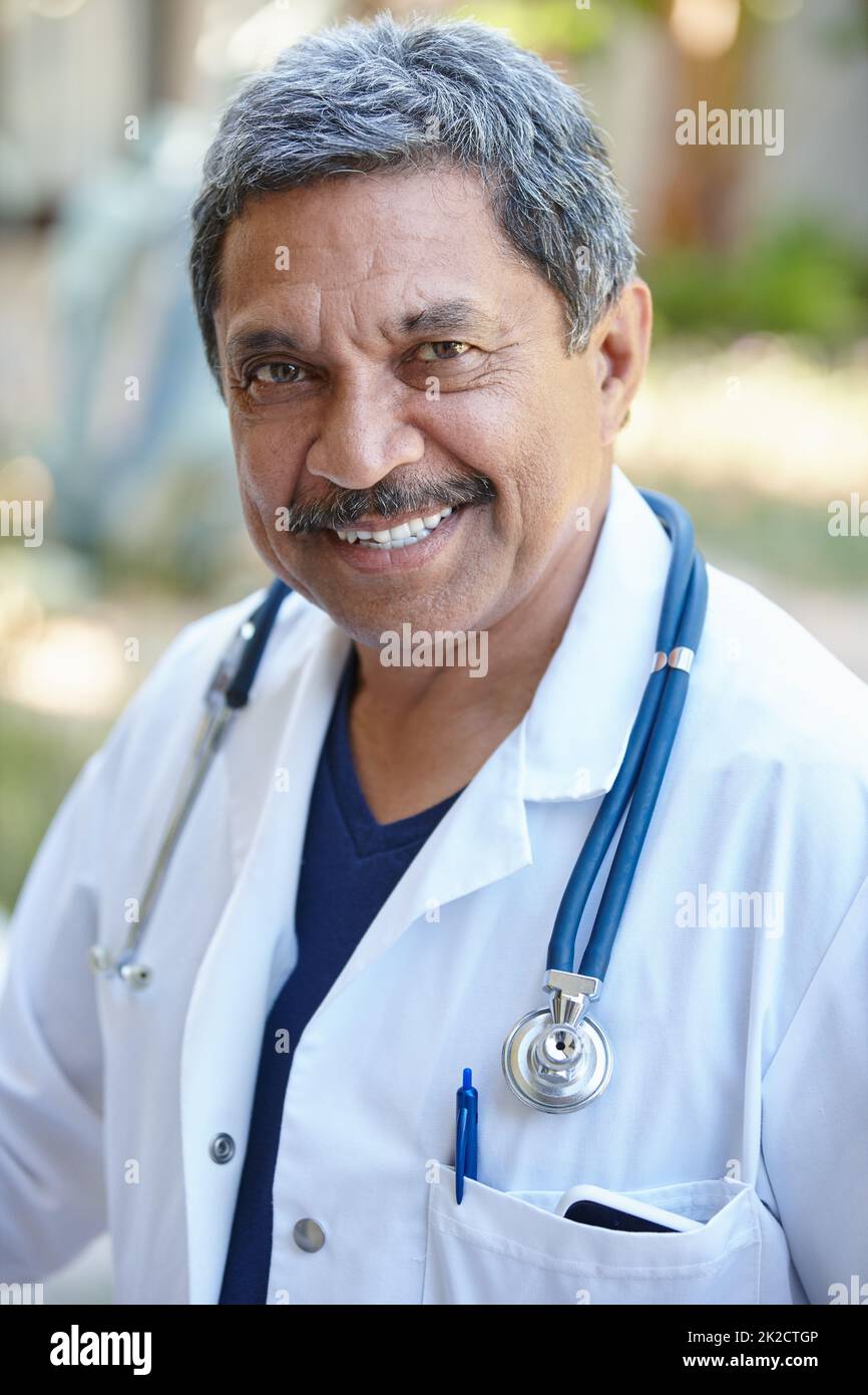 Being a doctor is so fulfilling. Cropped portrait of a male doctor smiling happily outside. Stock Photo