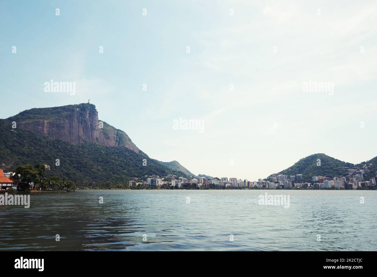 One of the few places man can live in natures beauty. Cropped shot of a city on the coastline with mountains surrounding it. Stock Photo