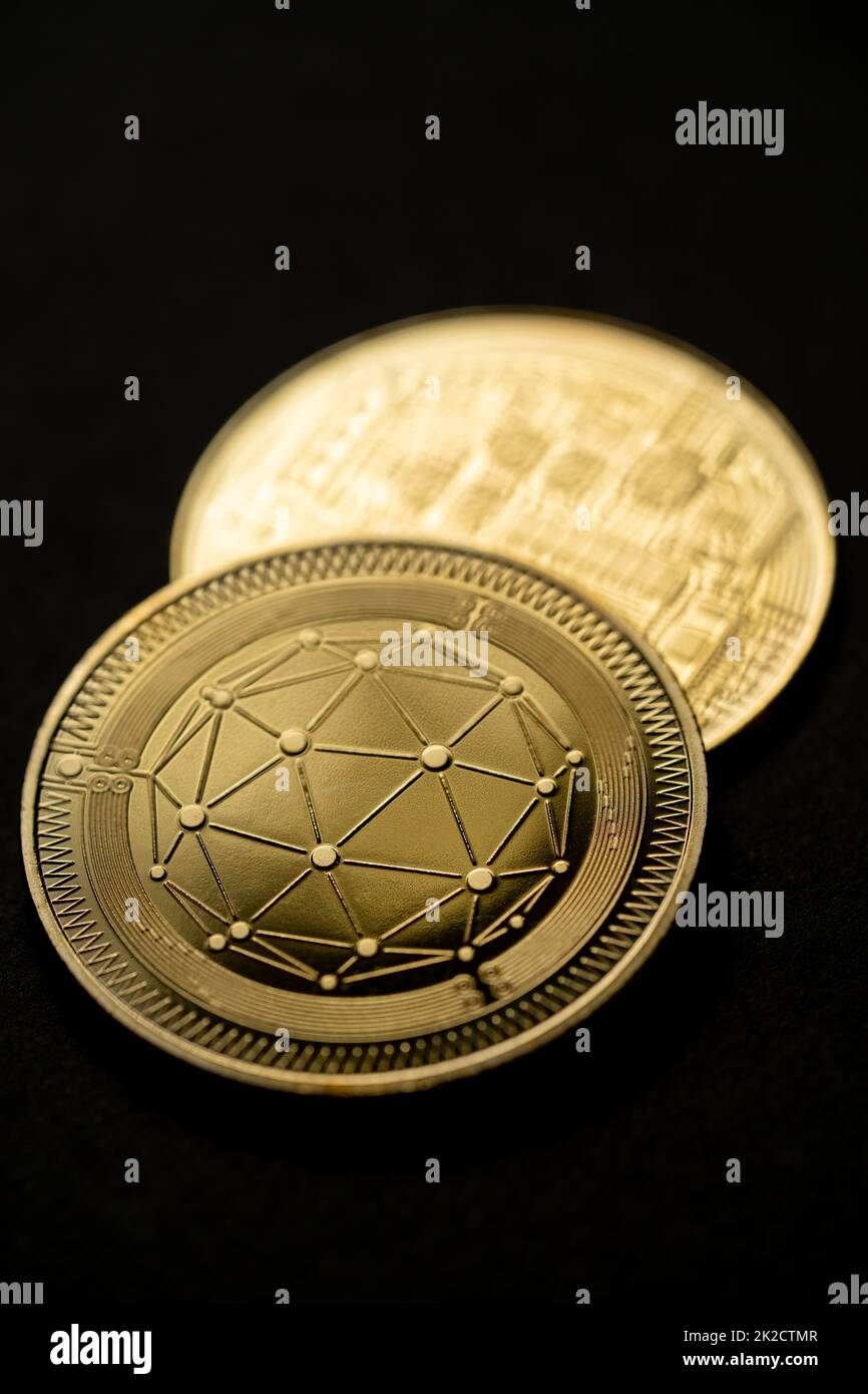 Close up shot of a golden Qtum digital cryptocurrency. Stock Photo