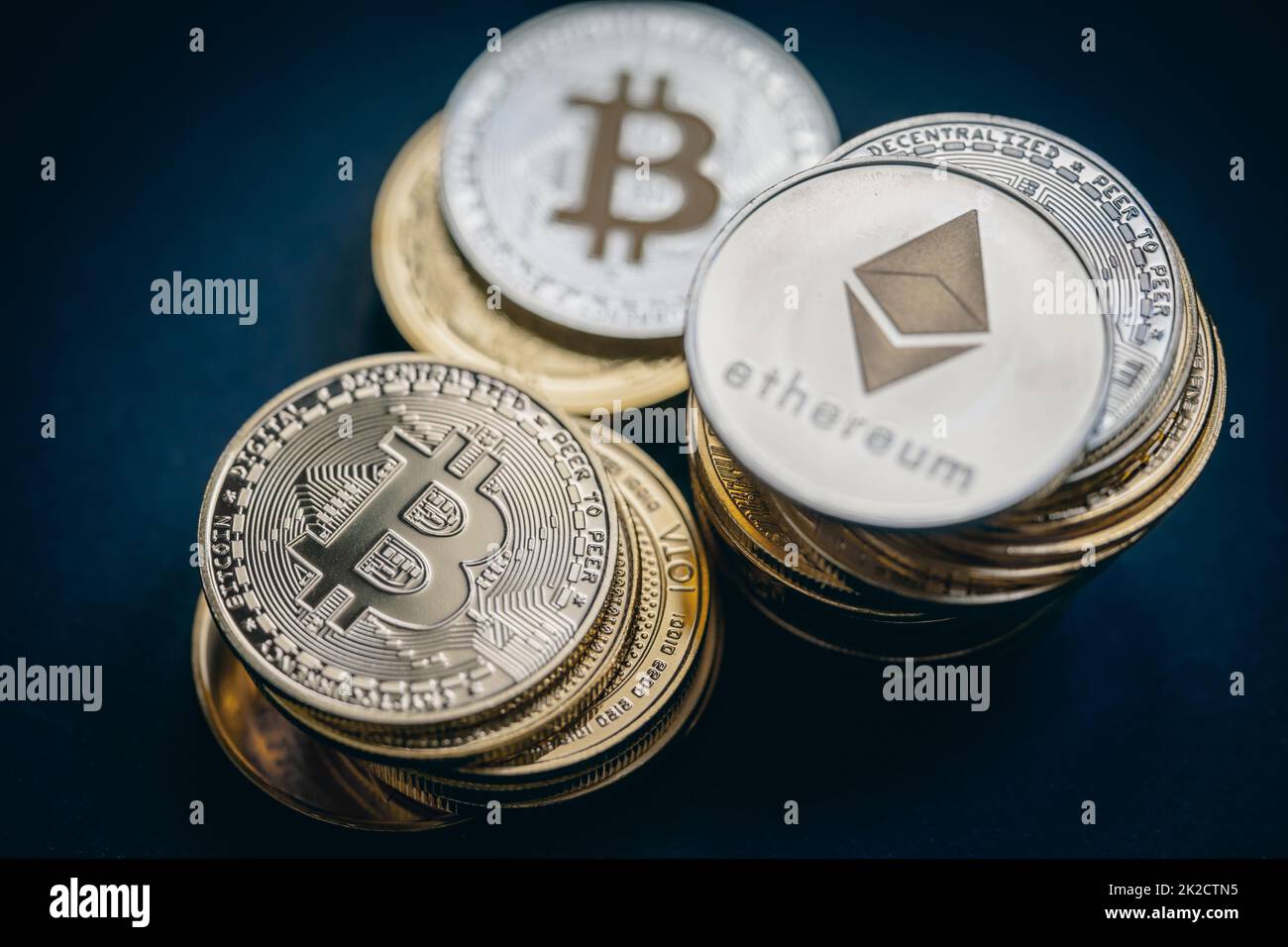 Close up shot of stacks of golden and silver Bitcoin and Ethereum digital cryptocurrency. Stock Photo
